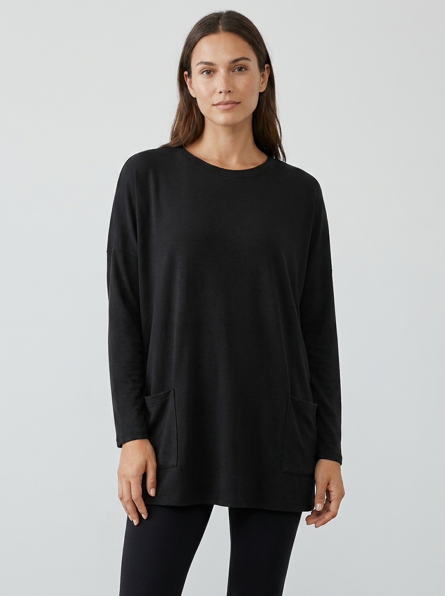 Women's oversized long-sleeve pocket tunic top in black, front view
