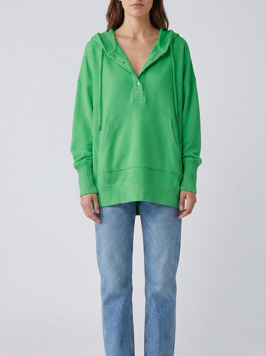 Woman wearing green oversized hooded drawstring tunic top
