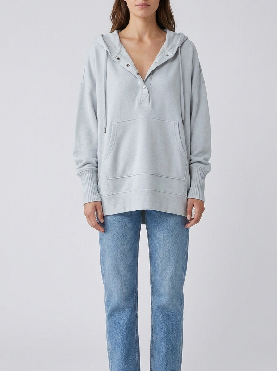 Woman wearing light grey oversized hooded drawstring tunic top