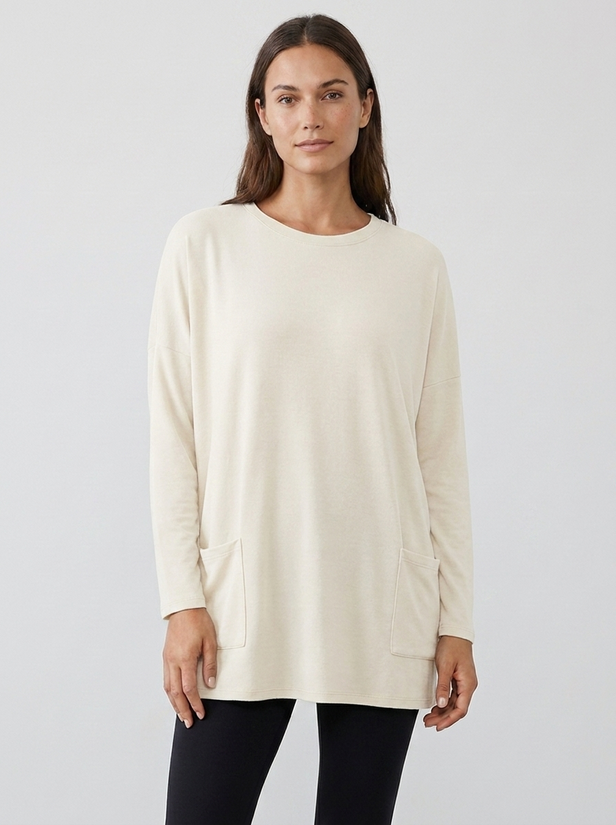 Women's oversized long-sleeve pocket tunic top in white, front view