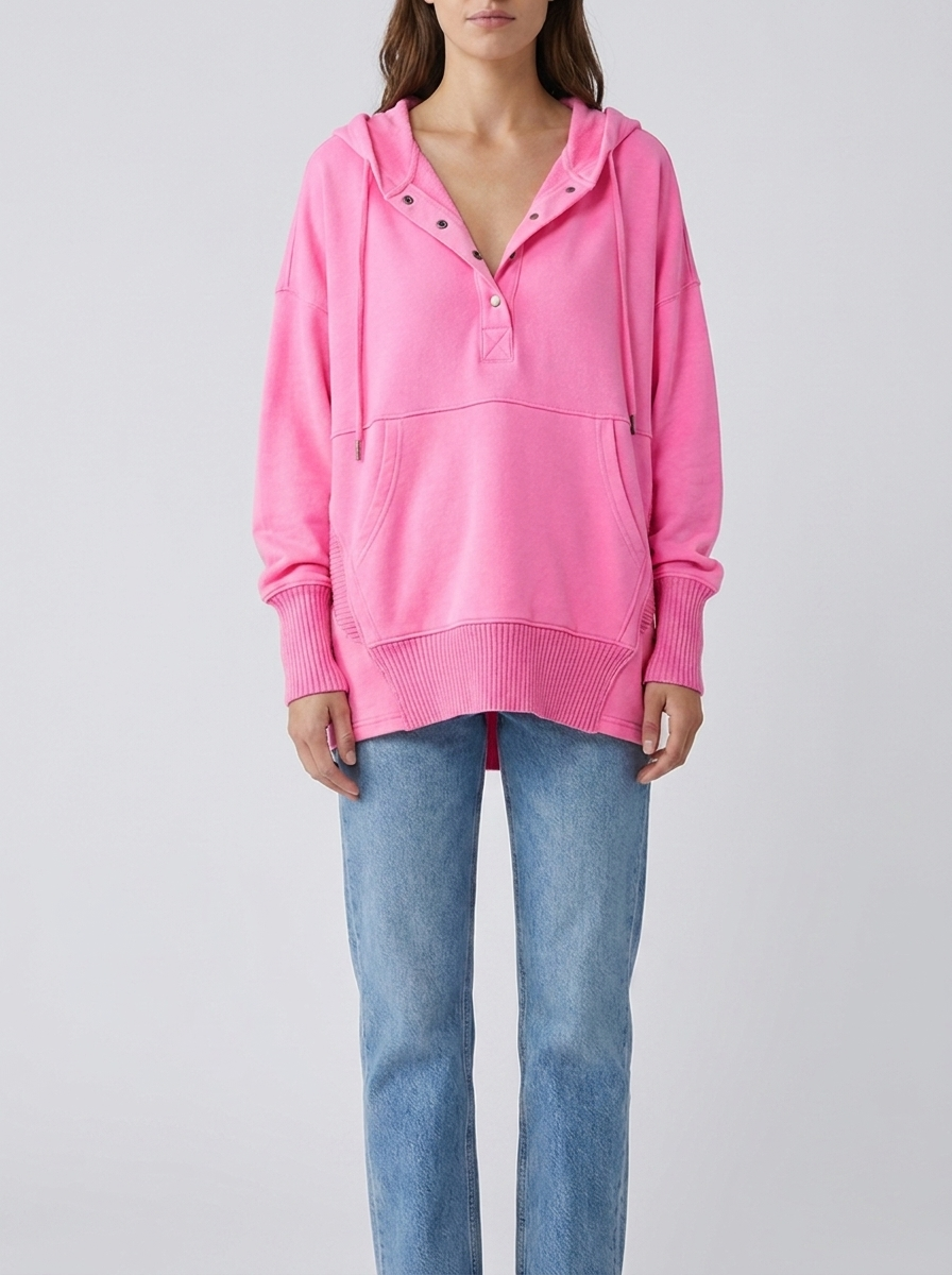 Woman wearing bright pink oversized hooded drawstring tunic top