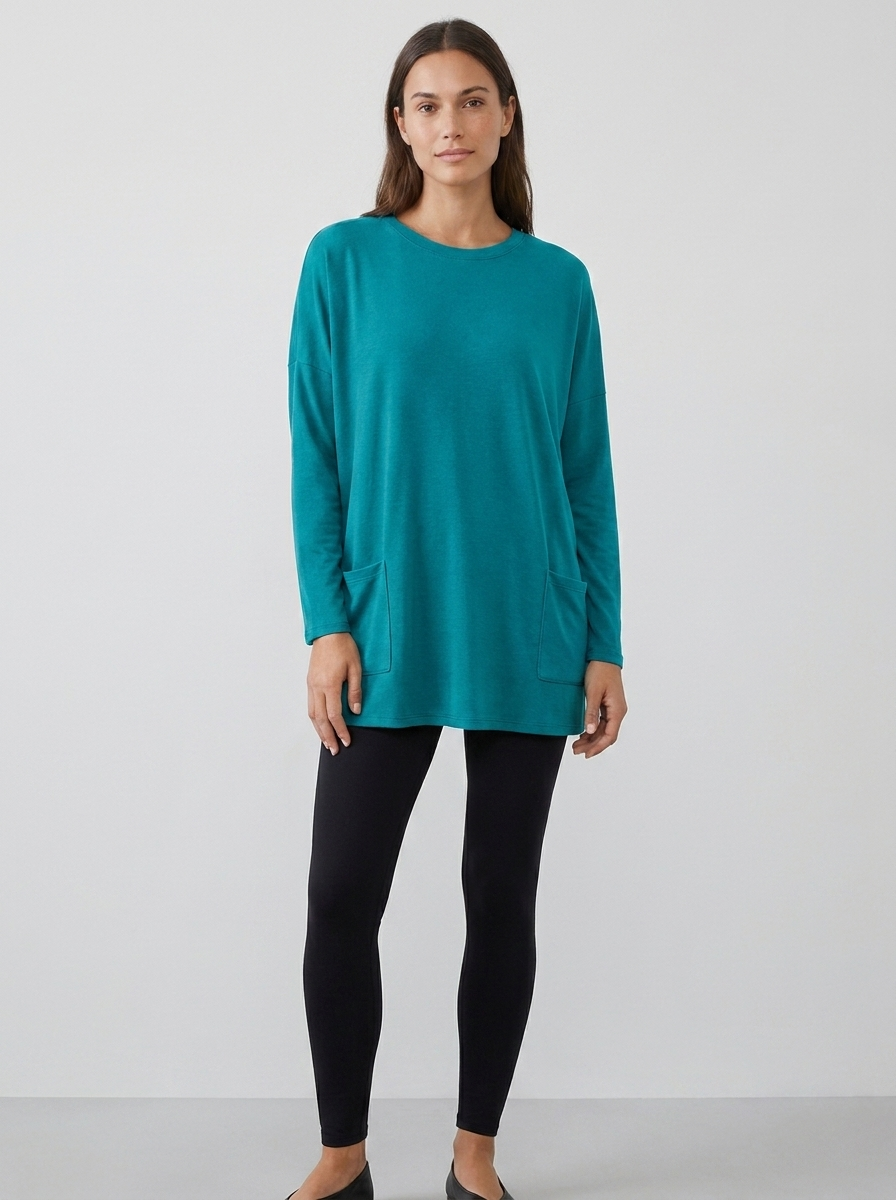 Women's oversized long-sleeve pocket tunic top in turquoise, front view
