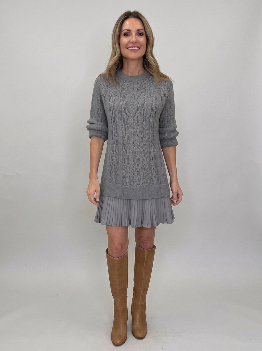 Woman wearing gray cable-knit sweater mini dress with pleated ruffle hem