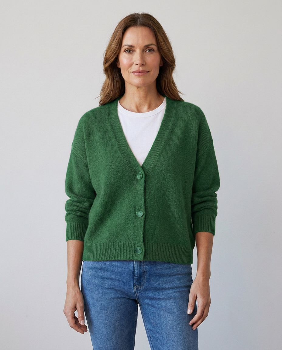 Women's relaxed knit button-front V-neck cardigan in green, worn over a white tee with jeans