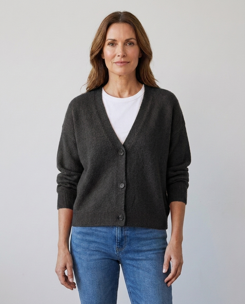Women's relaxed knit button-front V-neck cardigan in black, worn over a white tee with jeans