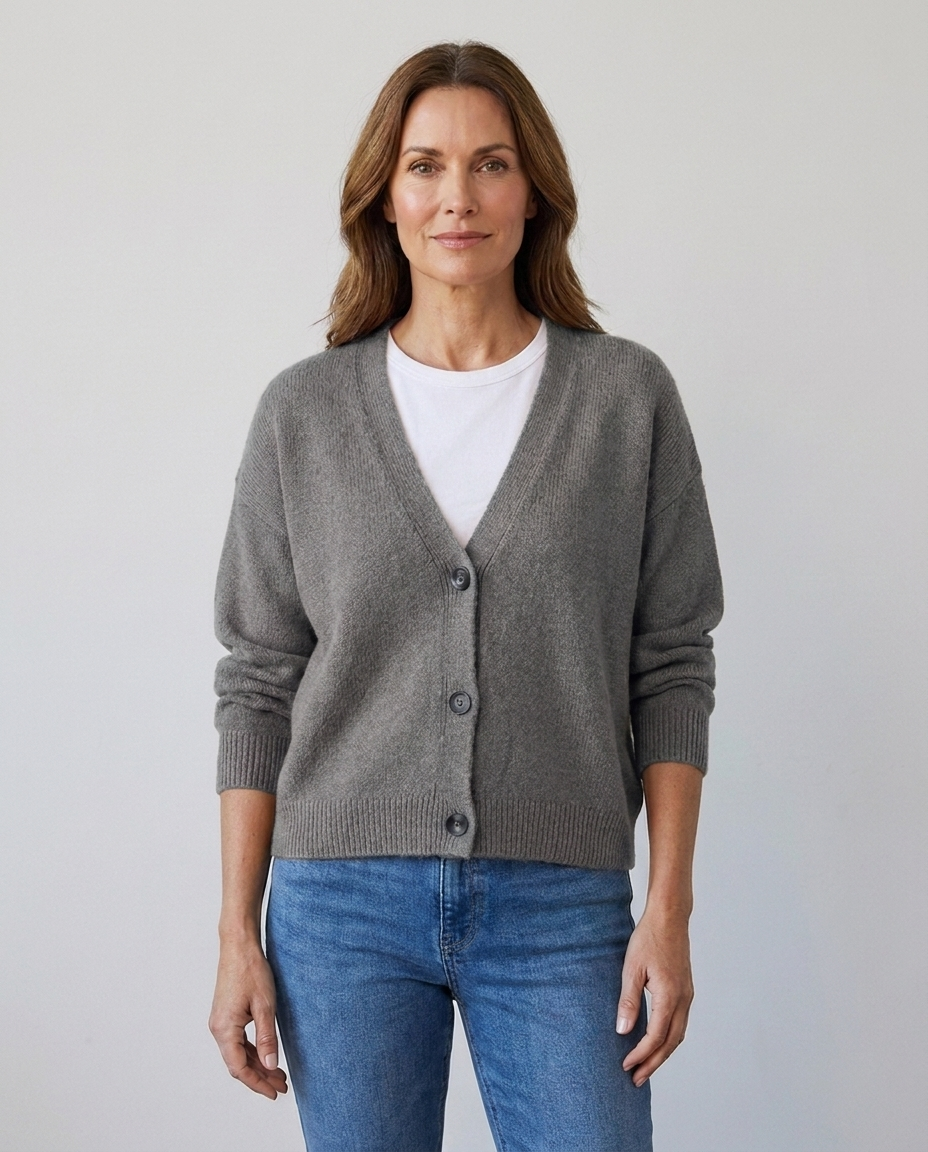 Women's relaxed knit button-front V-neck cardigan in gray, worn over a white tee with jeans