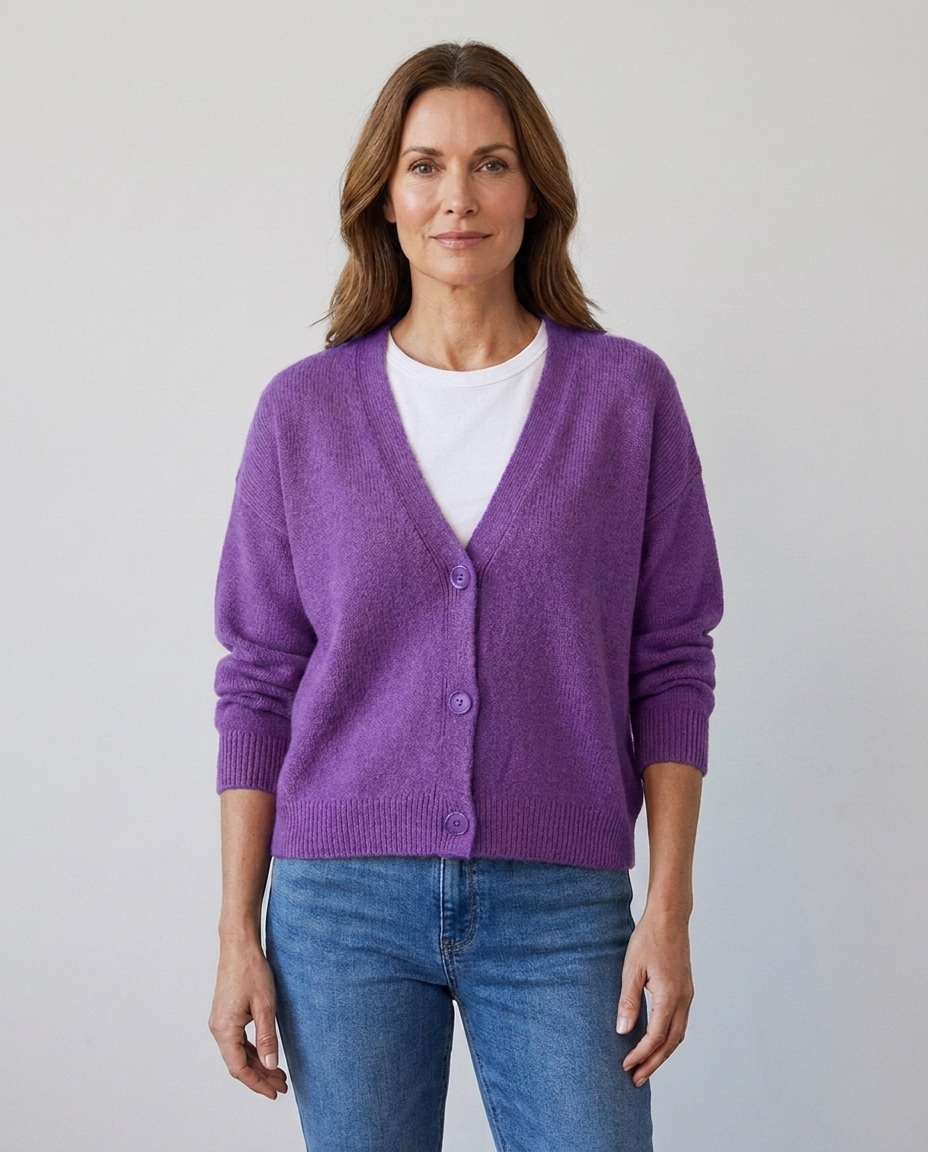 Women's relaxed knit button-front V-neck cardigan in purple, worn over a white tee with jeans
