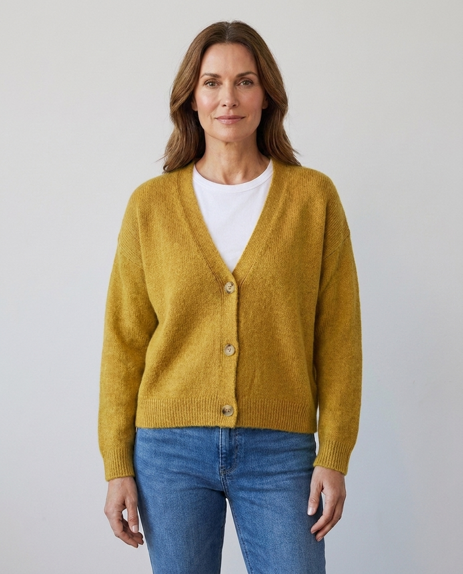 Women's relaxed knit button-front V-neck cardigan in yellow, worn over a white tee with jeans