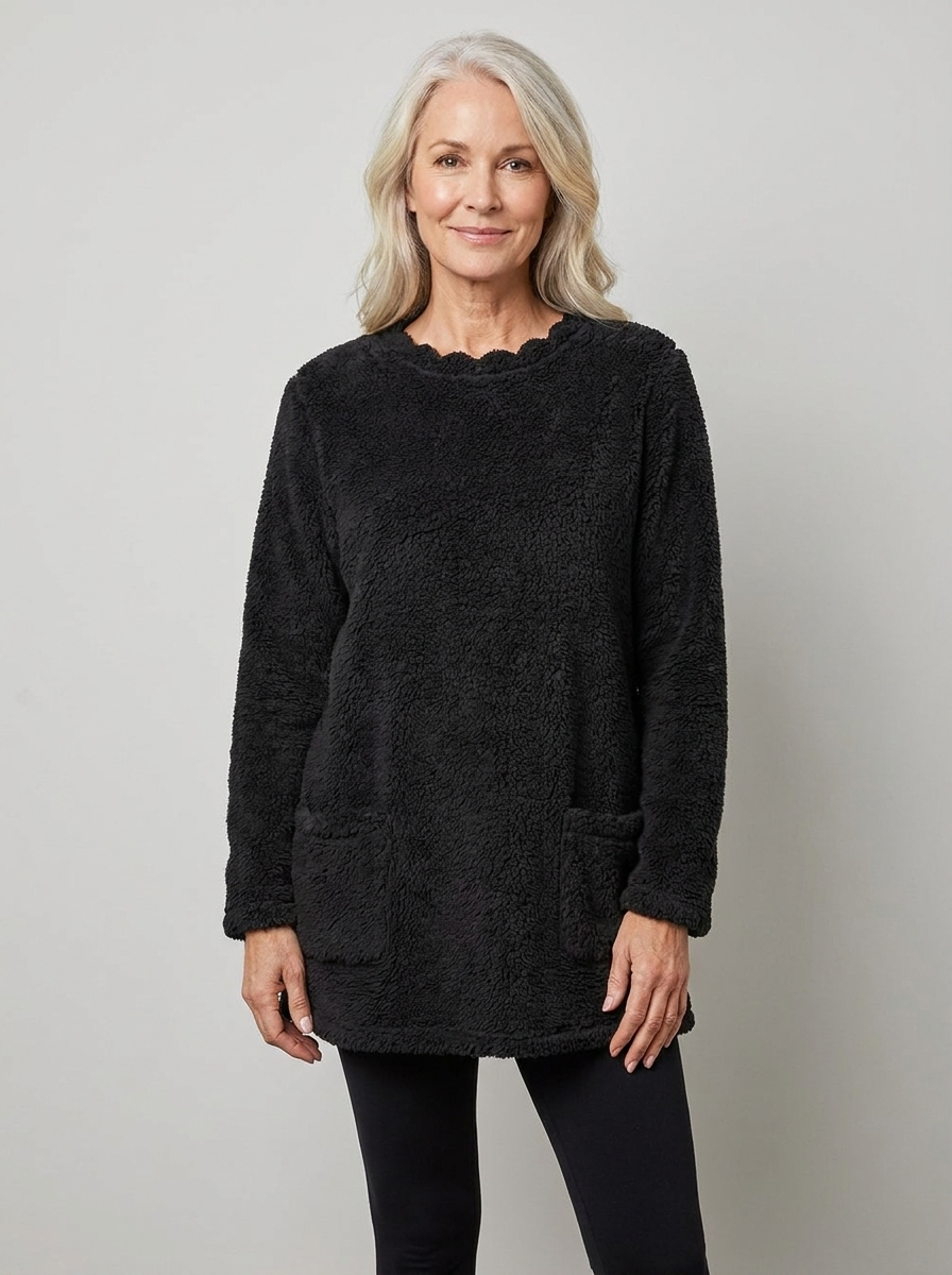 Woman wearing black sherpa fleece tunic sweater, front