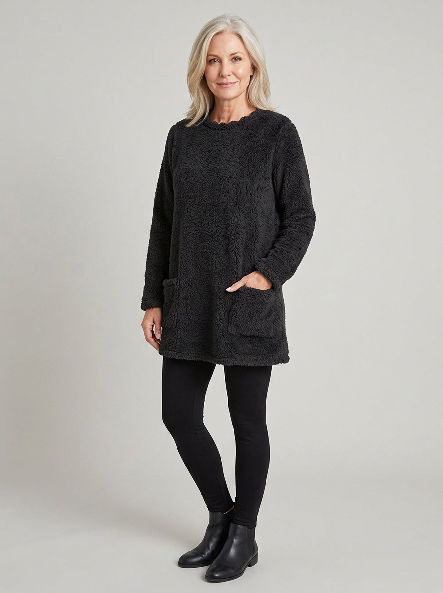 Woman wearing black sherpa fleece tunic sweater, three-quarter view