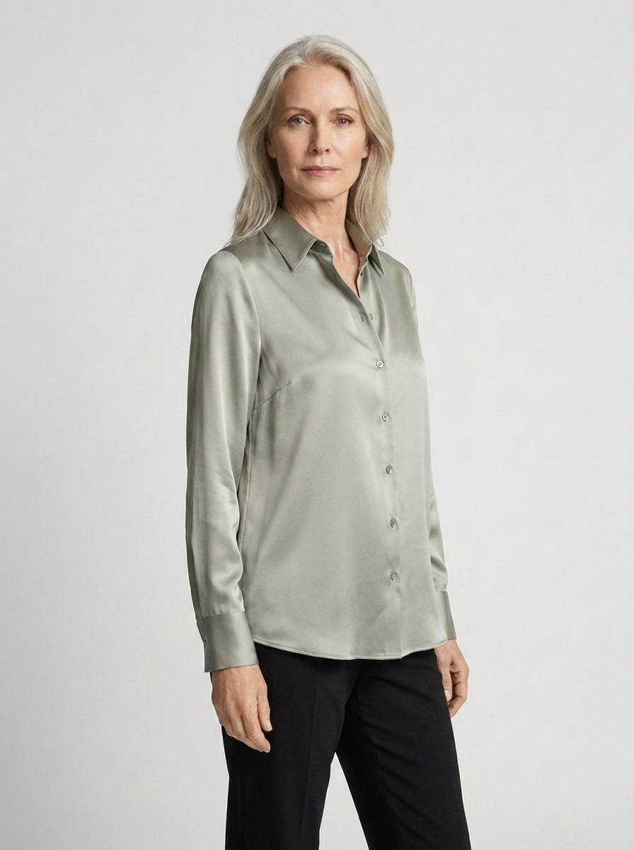 Woman wearing green satin blouse three-quarter
