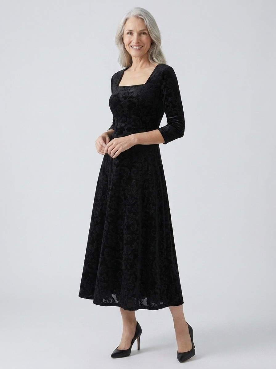 Delphine embossed velvet A-line midi dress on model, black, three-quarter