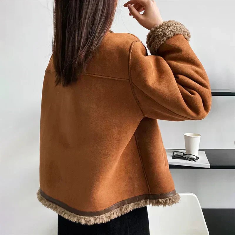 Back view of the tan faux shearling cropped jacket with shearling hem and cuffs
